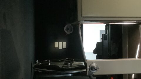 An IMAX 70mm film projector with a reel of film