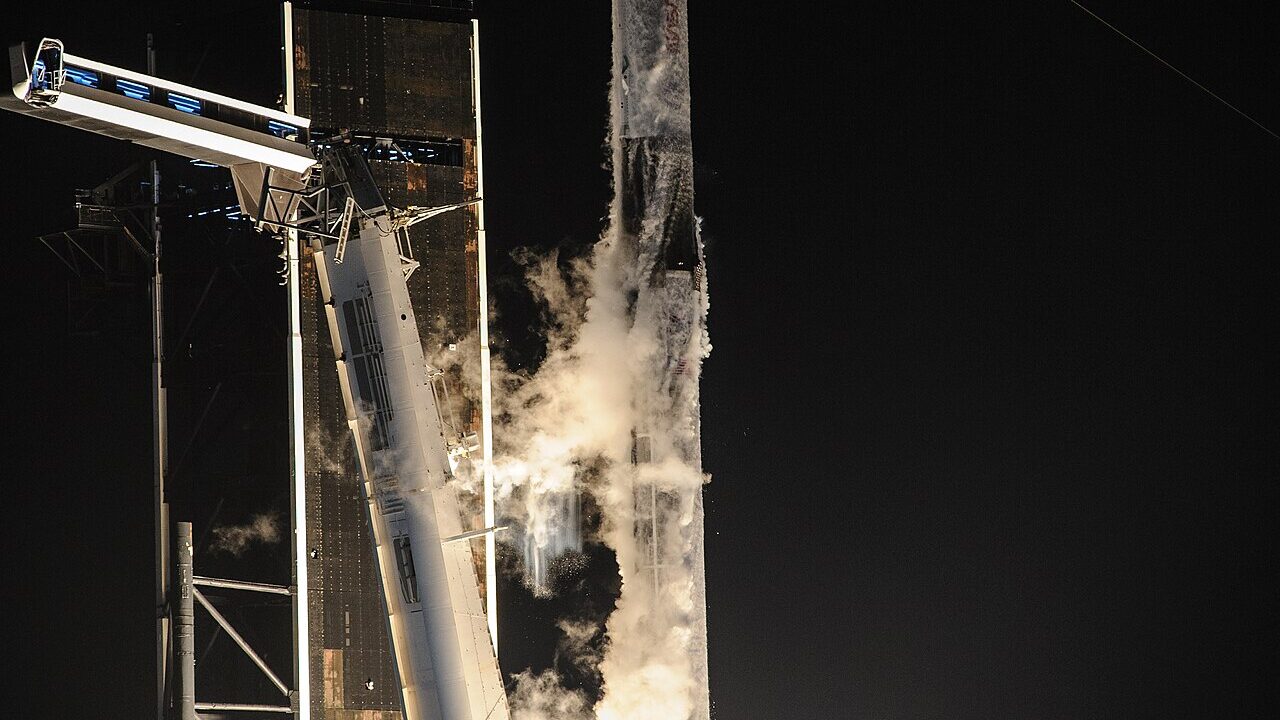 A Falcon 9 rocket lifting off at night