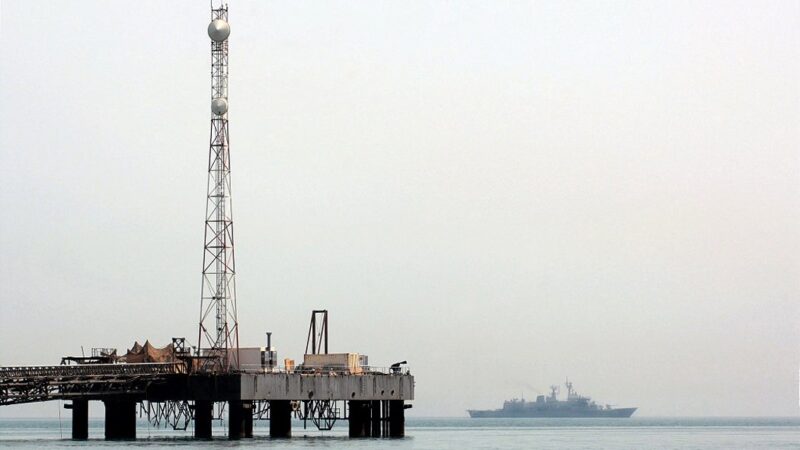 Warship patrolling the Persian Gulf near an oil platform