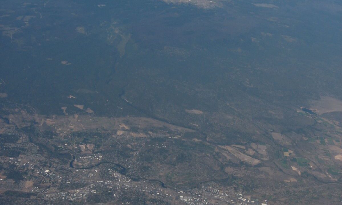 Aerial view of Bend Oregon with the Cascade mountains beyond