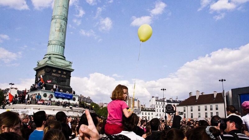 Crowd gathered at a demonstration in Paris in a public square