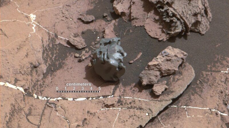 NASA Curiosity rover examining a meteorite on Mars