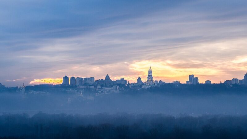Kyiv skyline at dawn with morning mist over the city