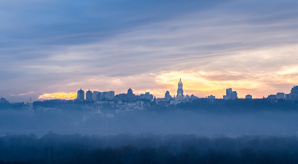 Kyiv skyline at dawn with morning mist over the city