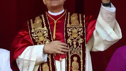 Pope Leo XIV in papal vestments waving to the crowd
