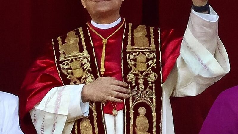 Pope Leo XIV in papal vestments waving to the crowd