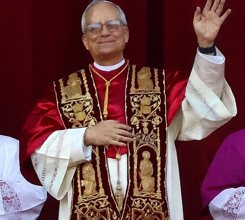 Pope Leo XIV in papal vestments waving to the crowd