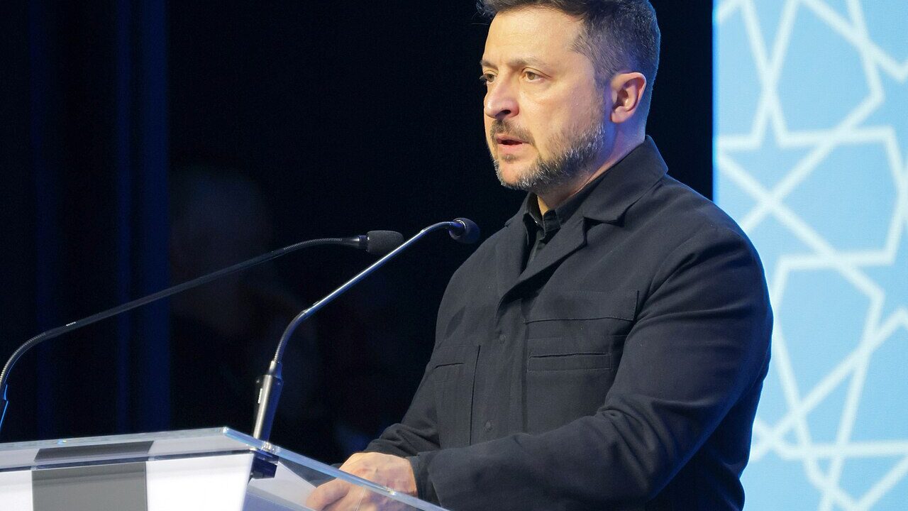 Volodymyr Zelenskyy speaking at a podium during the 2026 NATO Summit