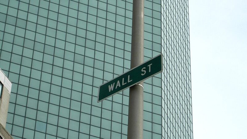 Wall Street street sign against a glass office tower